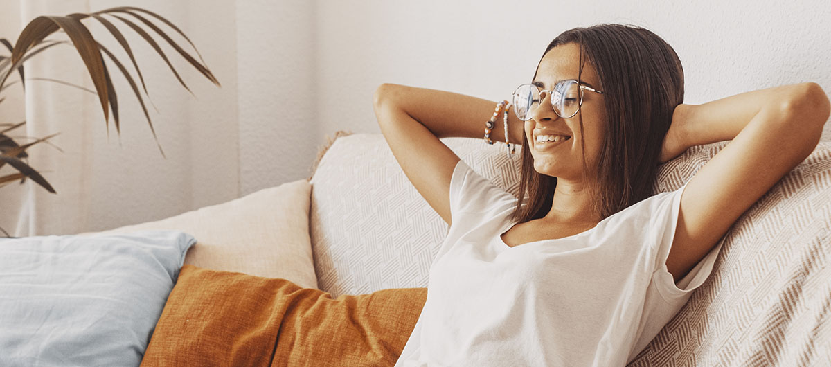 Black Cherry Punch Strain Review: What Is It And How Does It Affect You? 5 happy young woman in eyeglasses relaxing on sofa
